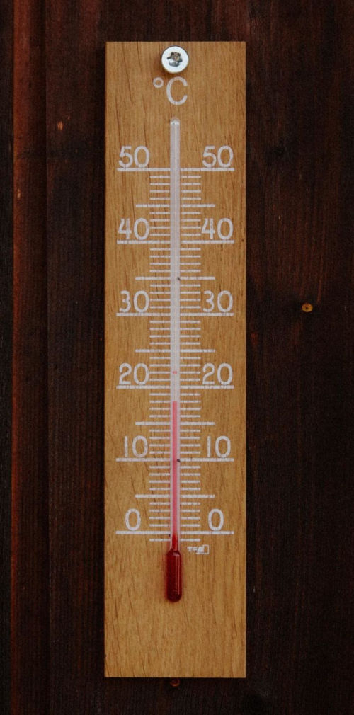 A thermometer on a wood surface 