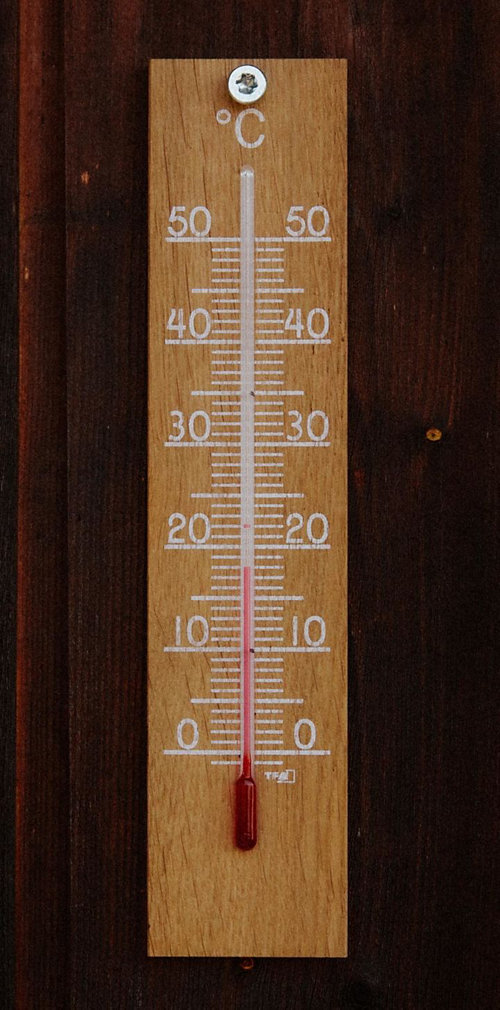 A thermometer on a wood surface 