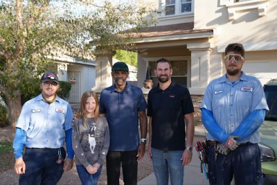Reginald Garnett and granddaughter with Parker & Sons employee