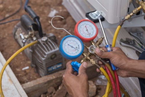 A person holding a pressure gauge