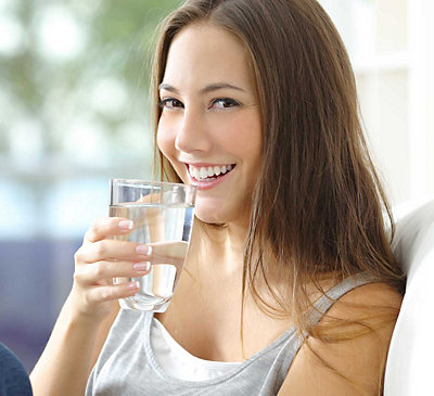 Woman smiling with glass of water