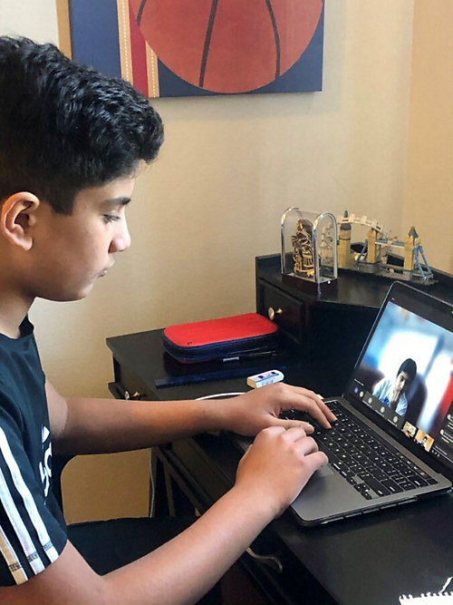 Richmond amazing kid Aryan Seetepalli at his laptop.