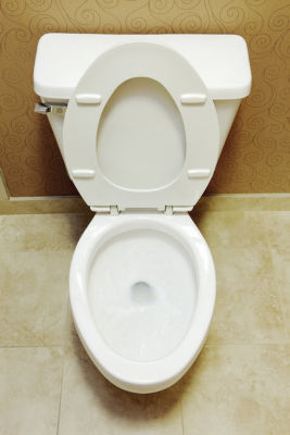 Closeup view of a flushing white toilet