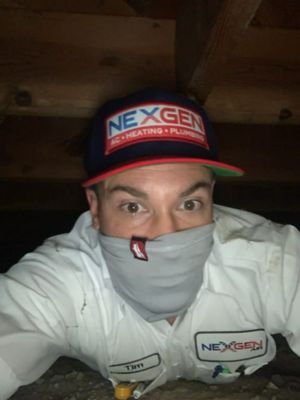 Technician wearing a face mask in the attic