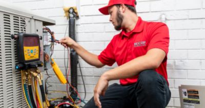 Red Cap tech checking a Heating System