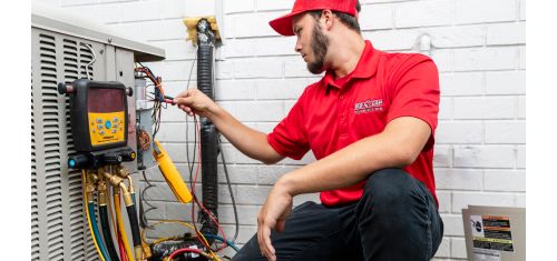 Red Cap tech checking a Heating System