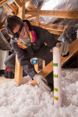 Tech installing insulation