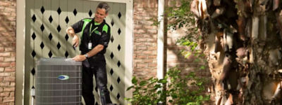 Technician working on an air conditioner - Williams Comfort Air Heating, Cooling, Plumbing & More