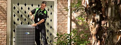 Technician working on an air conditioner - Williams Comfort Air Heating, Cooling, Plumbing & More