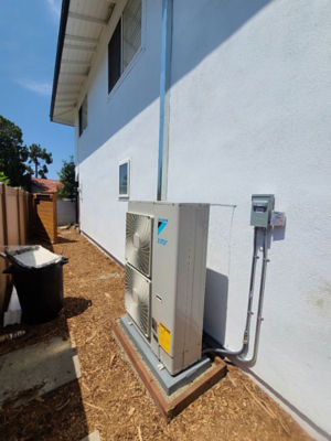 A compact AC unit connected to a home.