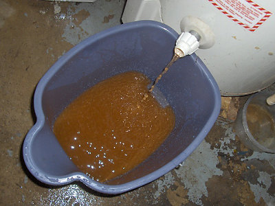 Rusty colored sludge draining out of water heater