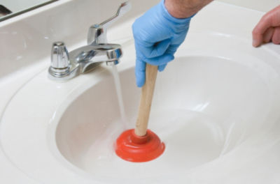 Red cup plunger for unclogging a drain.