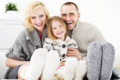 Family of three snuggling inside with warm socks on