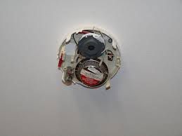 A smoke detector without a cover on it.