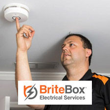 Electrician testing a smoke detector