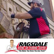 Electrician installing a light fixture at a home