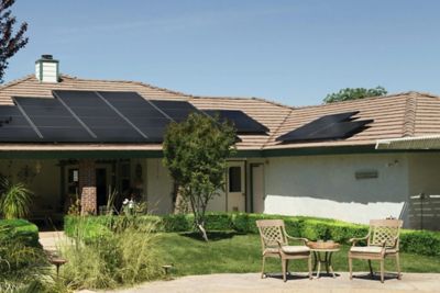 A home with solar panels on the roof in the sun