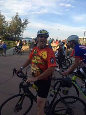 Volunteer riding a bike at Sports for a Cause