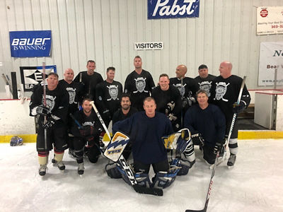 Volunteers playing hockey at Sports for a Cause