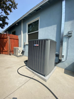 A NexGen AC unit on the side of a house.