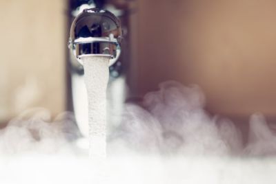 A faucet with running hot water