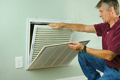 Man removing old air filter