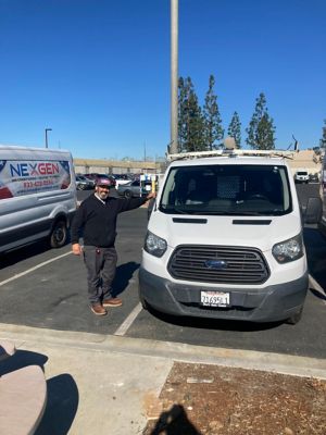 NexGen Employee standing next to van