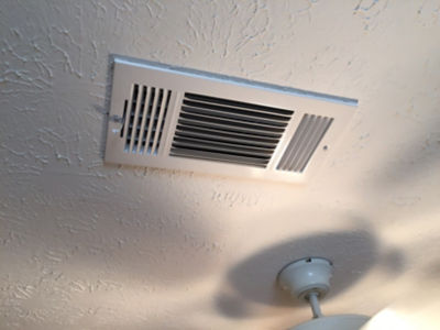 Vent in ceiling next to fan