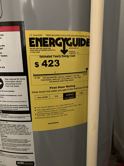 Diagram showing sediment buildup inside a water heCloseup shot of a yellow Energy Guide sticker on a water heater.