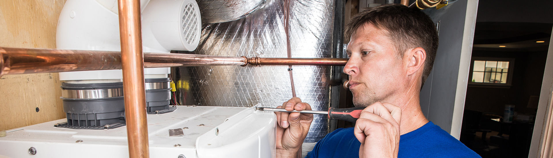 Plumber repairing a water heater