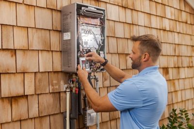 Electrician outdoors working on an electrical panel
