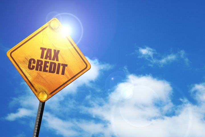 Yellow traffic sign that reads Tax Credit