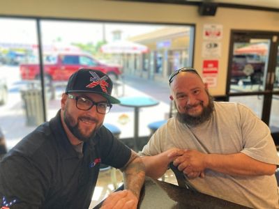 Tech and Customer Smiling at a desk