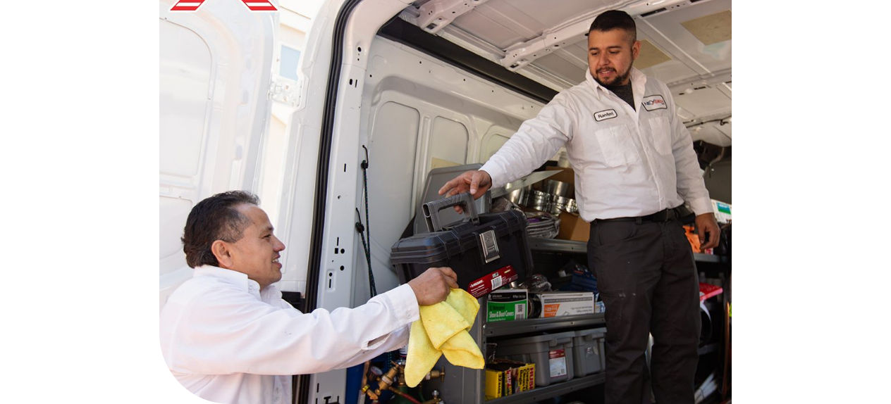 Tech handing tools out of the back of a van