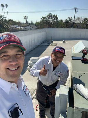 Two NexGen Techs taking a selfie on the roof of a building