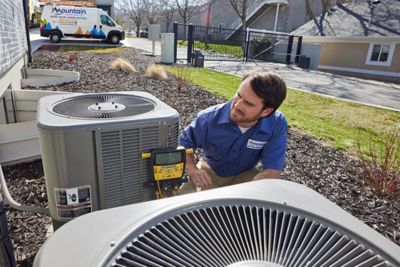 Tech outside testing a heat pump