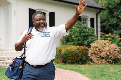 Tech leaving home waving at the neighbors