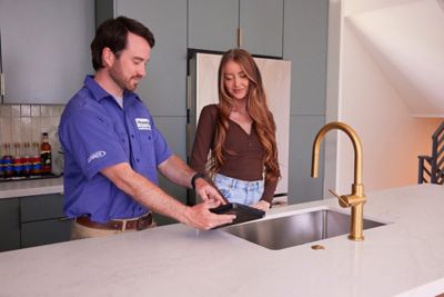 Tech in kitchen showing iPad to customer