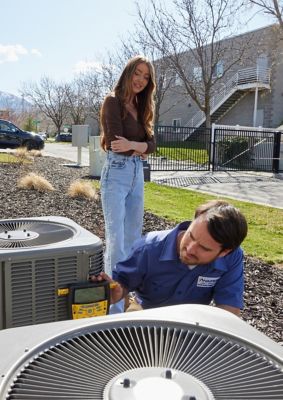 Tech Fixing Heat Pump With Customer