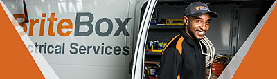 Electrician smiling by service vehicle