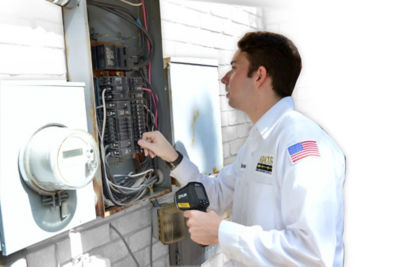A technician checking an electrical panel.