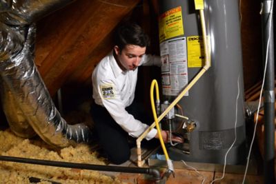 Technician checking water heater