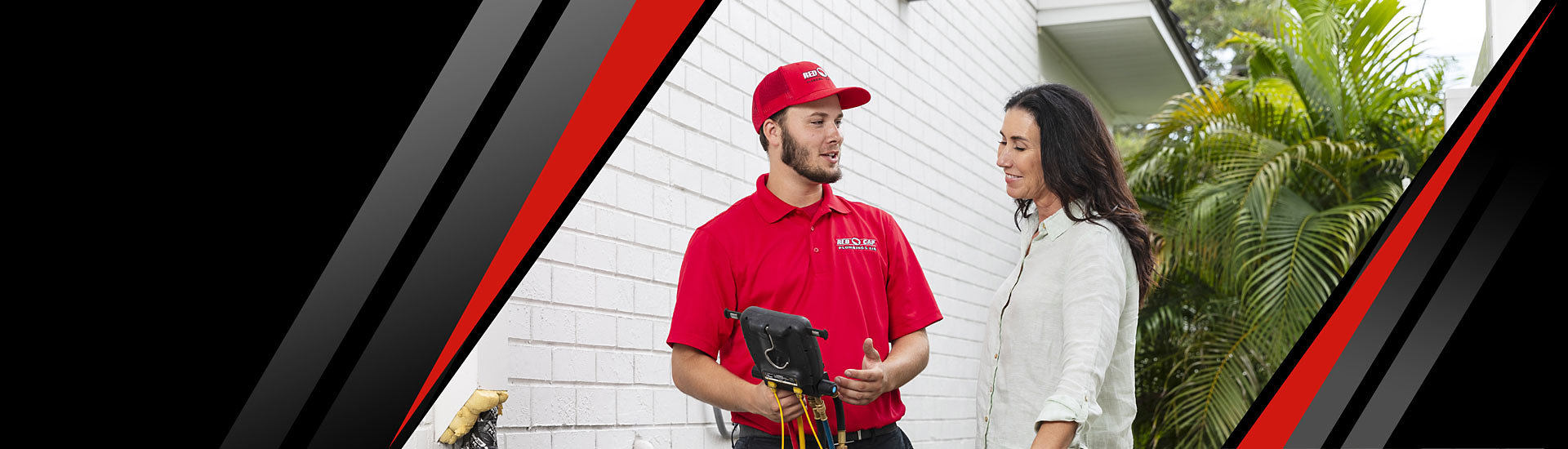 A Red Cap technician and a costumer standing next to an air conditioner