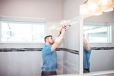 Plumber fixing a shower fixture in a St. Petersburg, FL home