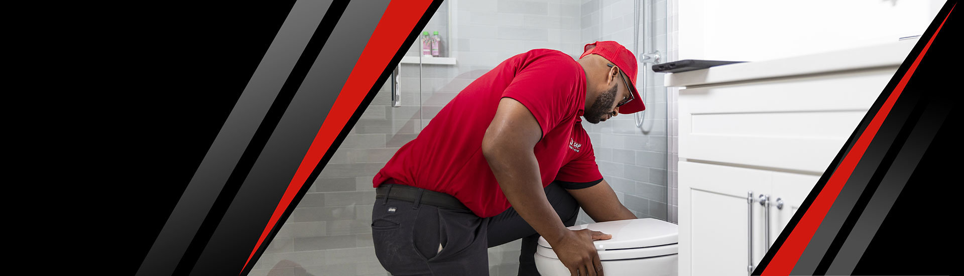 A Red Cap technician checking a toilet in a bathroom house