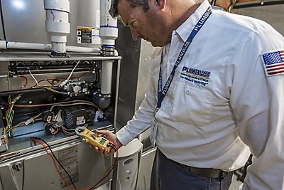 HVAC tech servicing a furnace in a Fort Collins, CO home