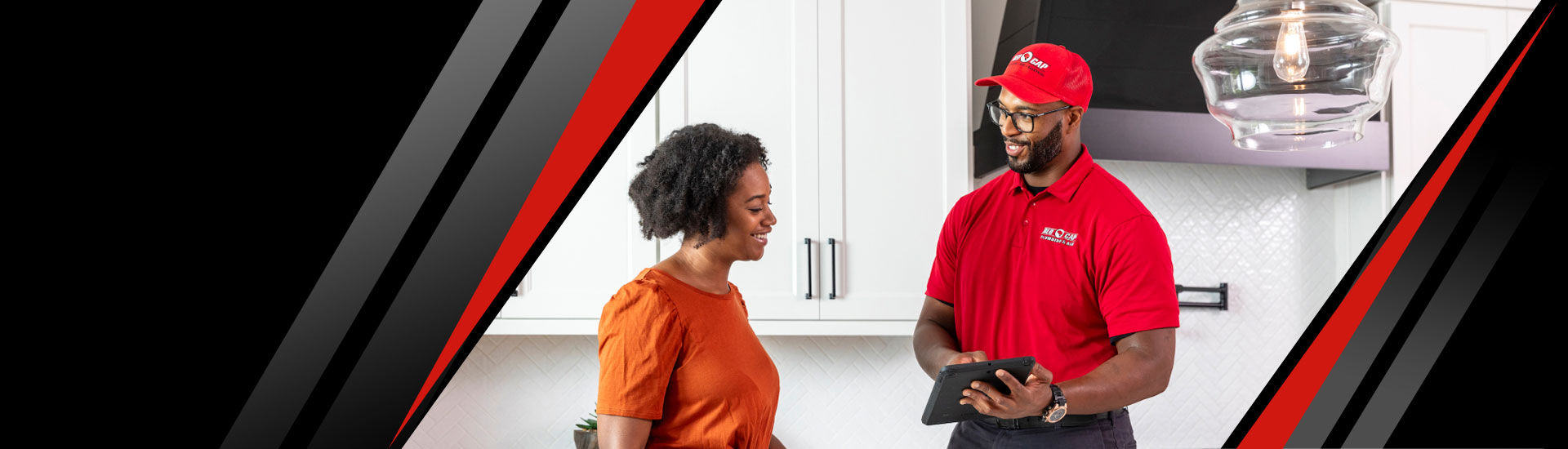 A Red Cap technician explaining a topic on a tablet to a happy customer