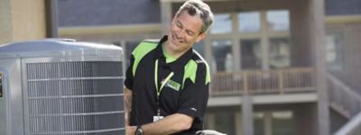 Technician working on an air conditioner or heat pump - Thomas & Galbraith Heating, Cooling, & Plumbing