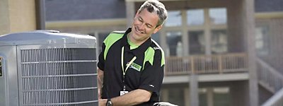 Technician working on an air conditioner or heat pump - Thomas & Galbraith Heating, Cooling, & Plumbing