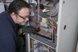 Tech looking over a gas furnace